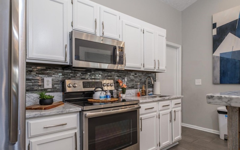 a kitchen with white cabinets