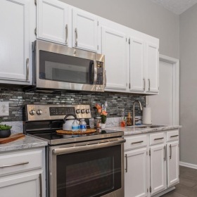 a kitchen with white cabinets