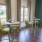 a room with a table chairs and a window