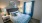 a bedroom with a bed and lamps
