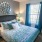 a bedroom with a bed and lamps