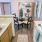 a kitchen with a sink and chairs